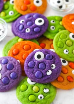 Close up of a pile of brightly colored Halloween Monster Cookies with eyeballs.