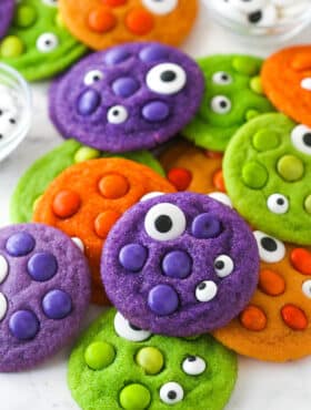 Close up of a pile of brightly colored Halloween Monster Cookies with eyeballs.