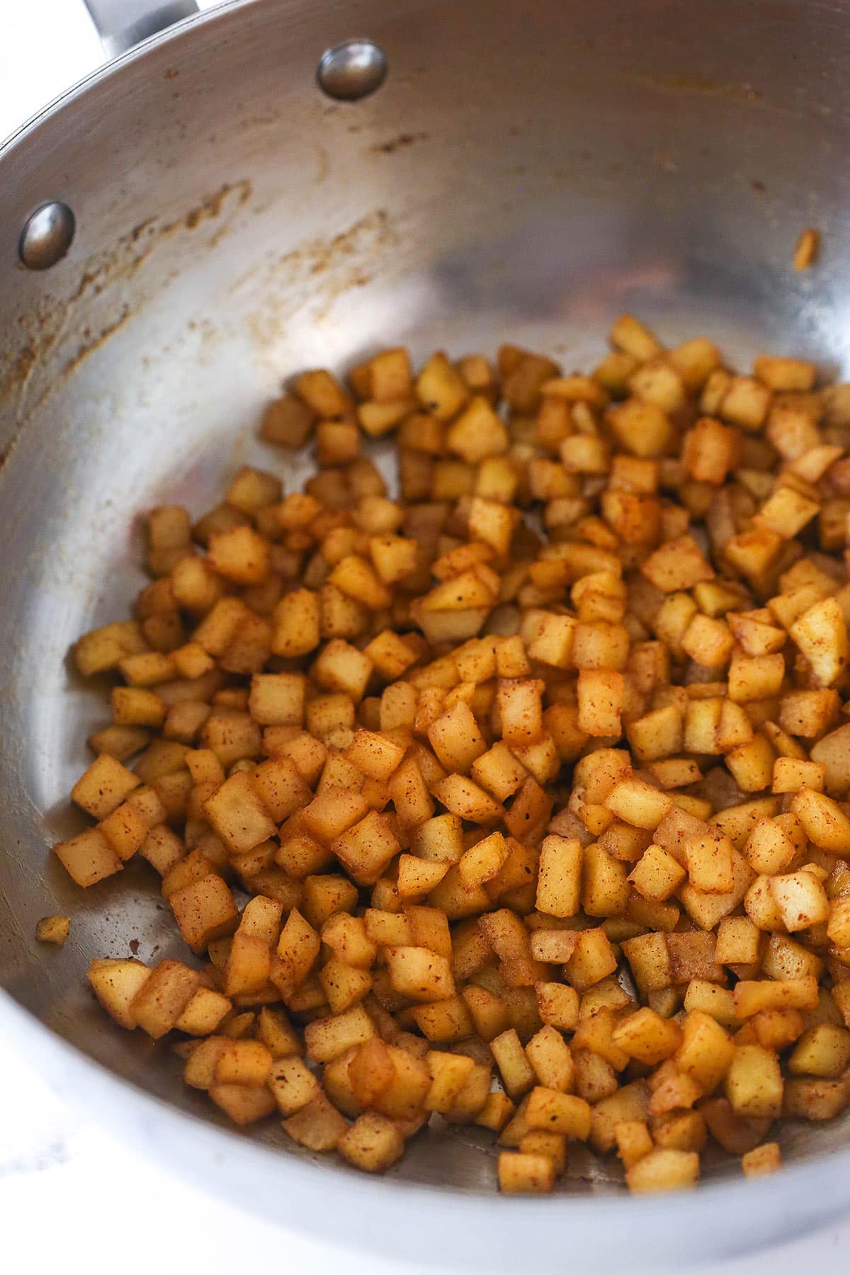 Cooking spiced apples for mini cheesecake topping.