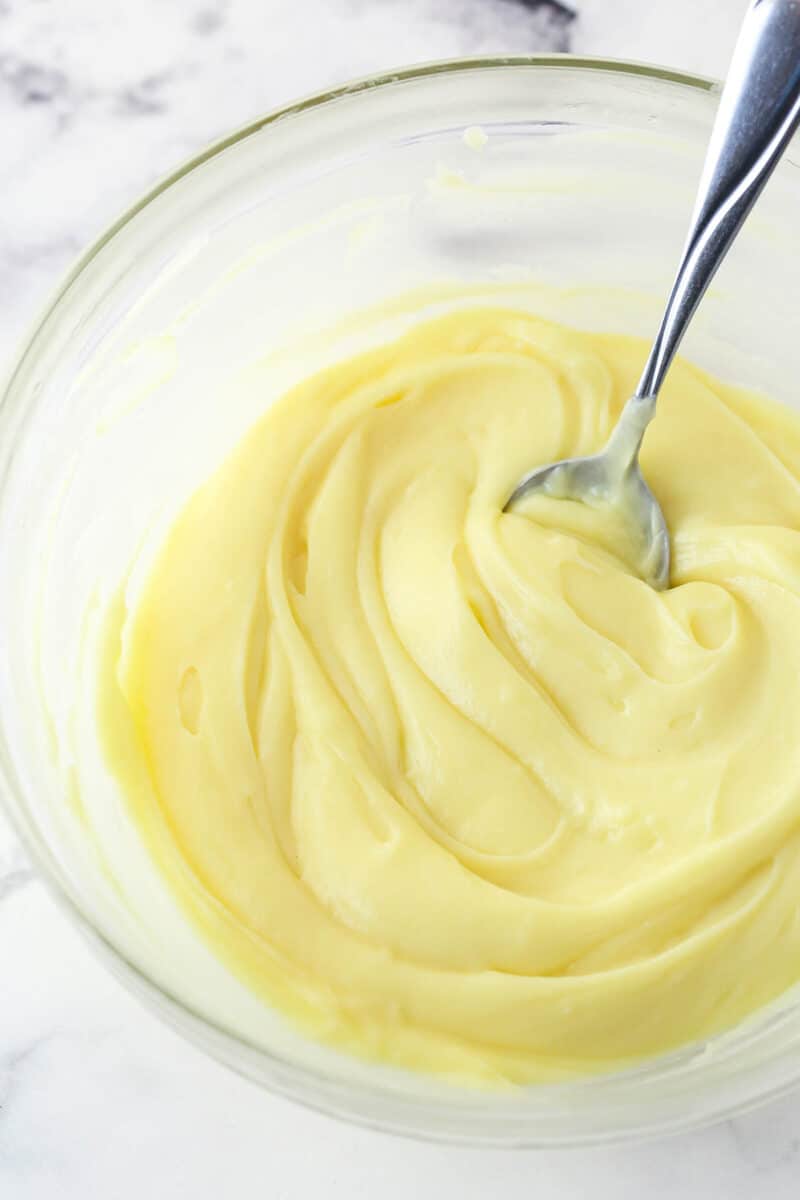 Stirring chilled pastry cream to make it smooth.