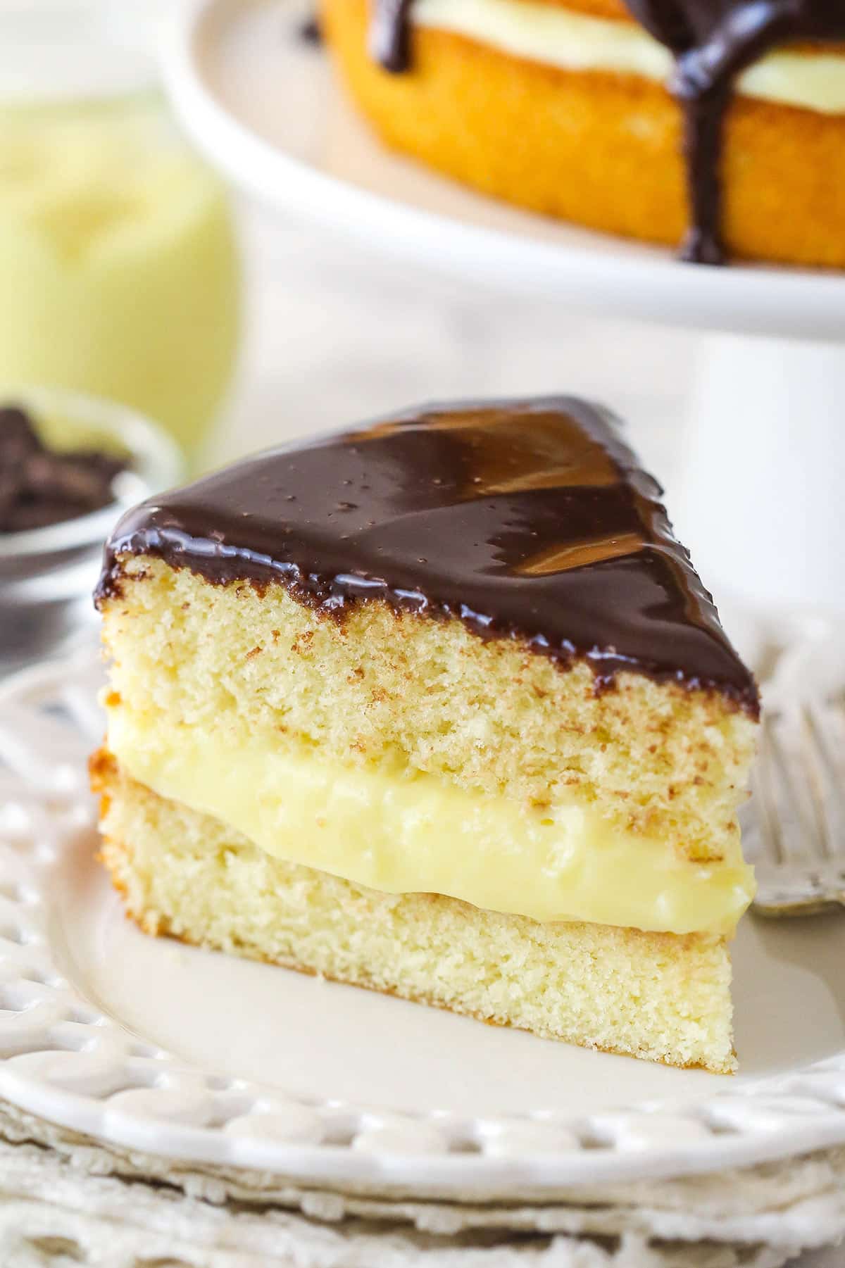 A slice of Boston cream pie on a plate.