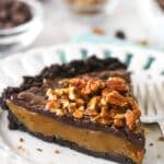 A slice of caramel turtle pie on a plate.