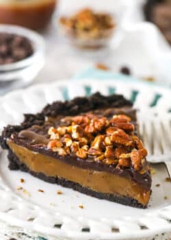 A slice of caramel turtle pie on a plate.