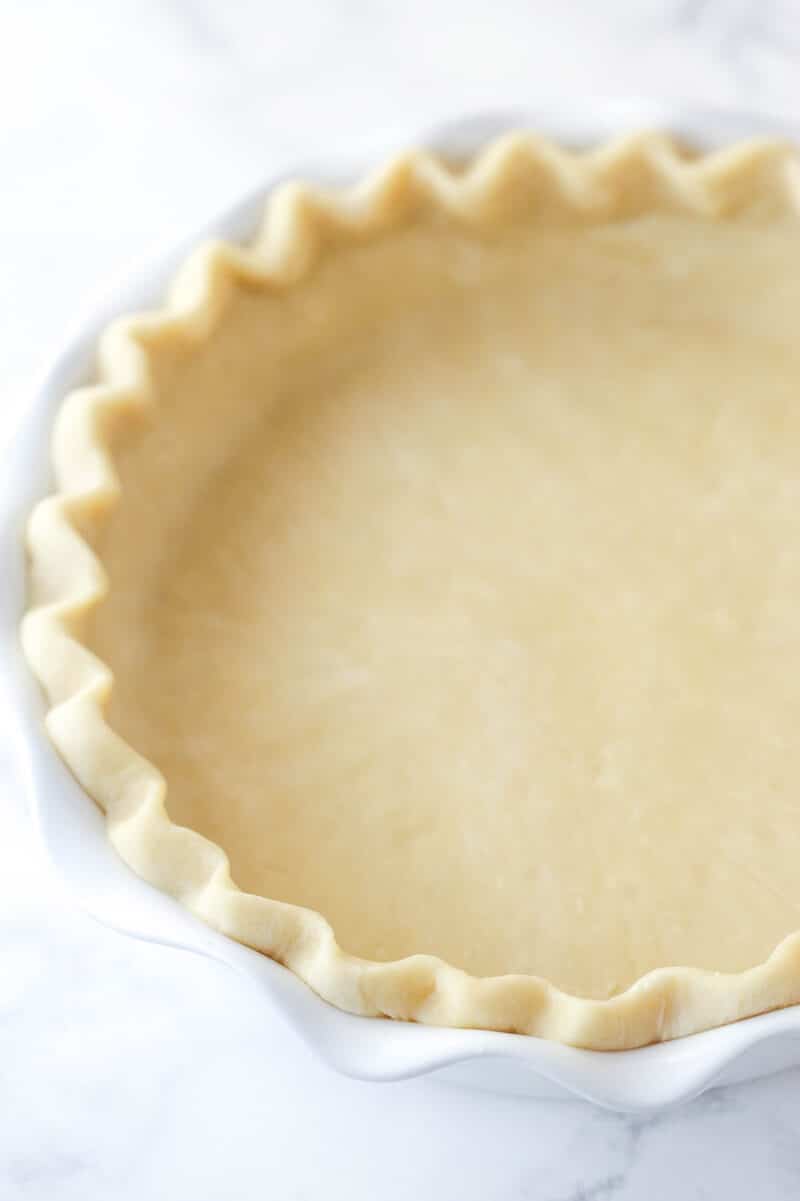 An unbaked pie crust in a pie pan.