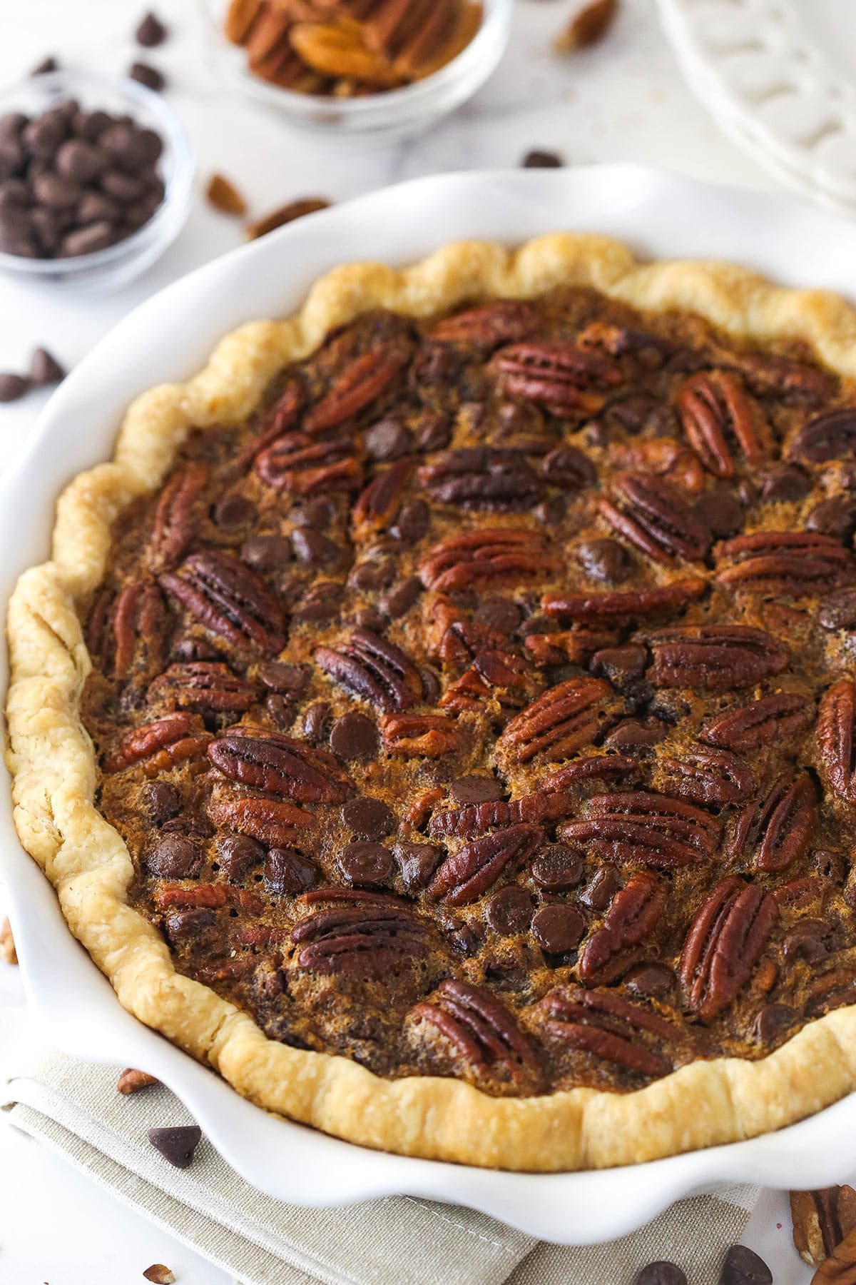 Chocolate pecan pie in a pie dish.