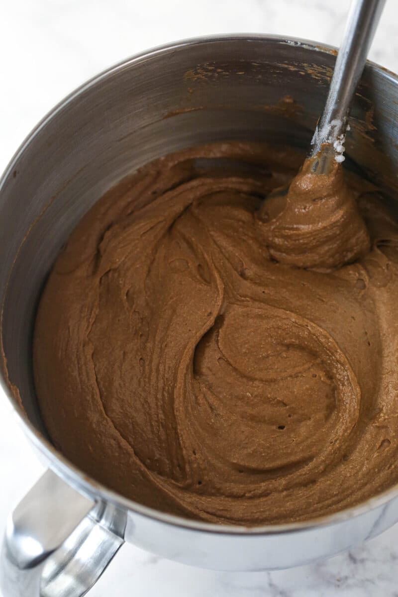 Folding whipped egg whites into chocolate cake batter.