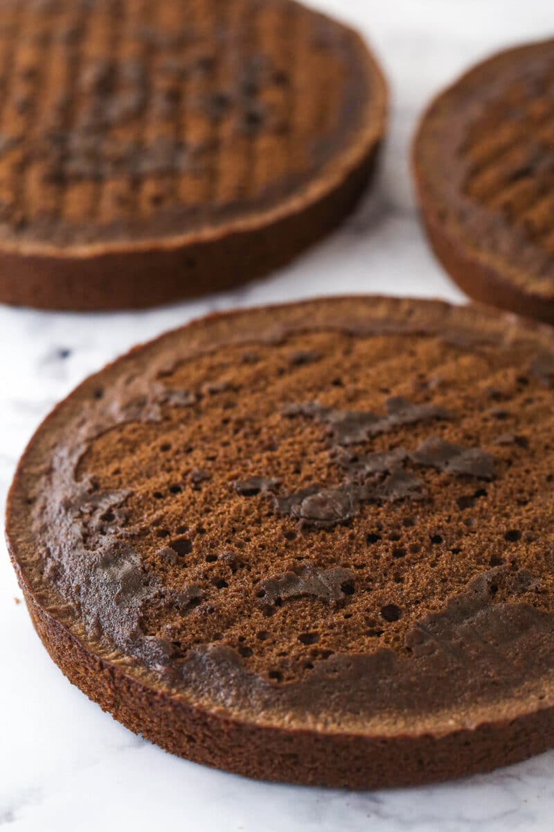 3 layers of German chocolate cake ready to be stacked, filled, and frosted.