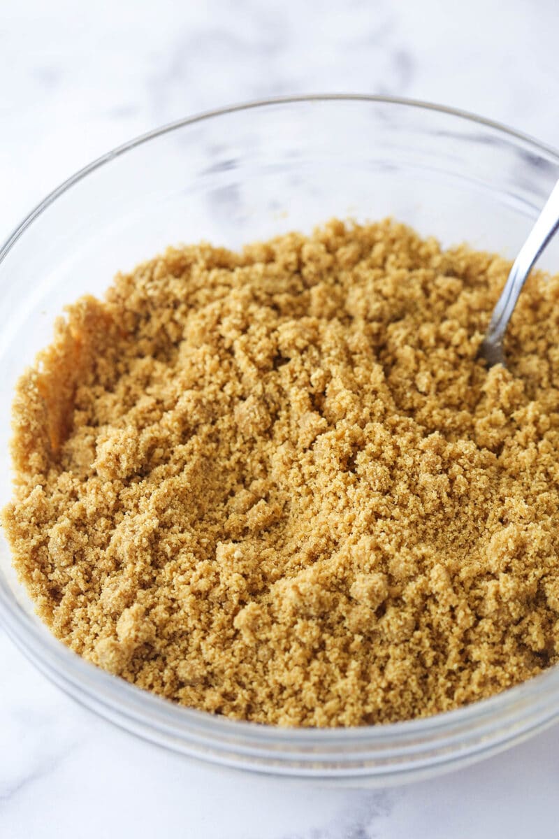 Mixing together ingredients for a graham cracker crust.