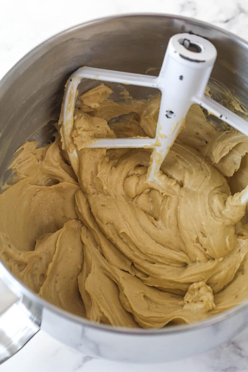 Mixing together cream cheese, dark brown sugar, and flour for cheesecake filling.