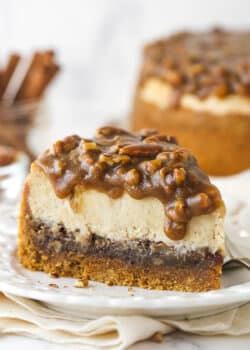 A slice of pecan pie cheesecake on a plate.