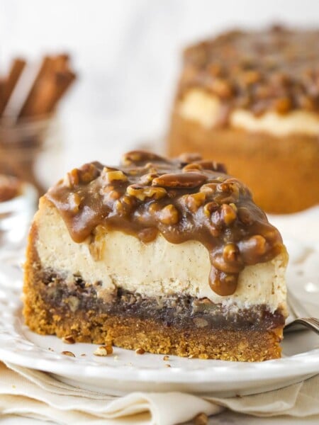 A slice of pecan pie cheesecake on a plate.