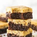 A stack of 3 Praline Pecan Brownies with a bite removed from top brownie.