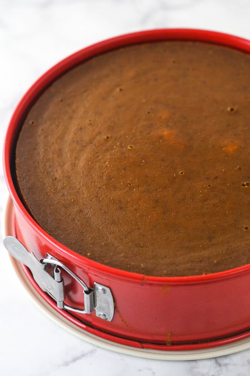 Pumpkin pie cheesecake in a springform pan.