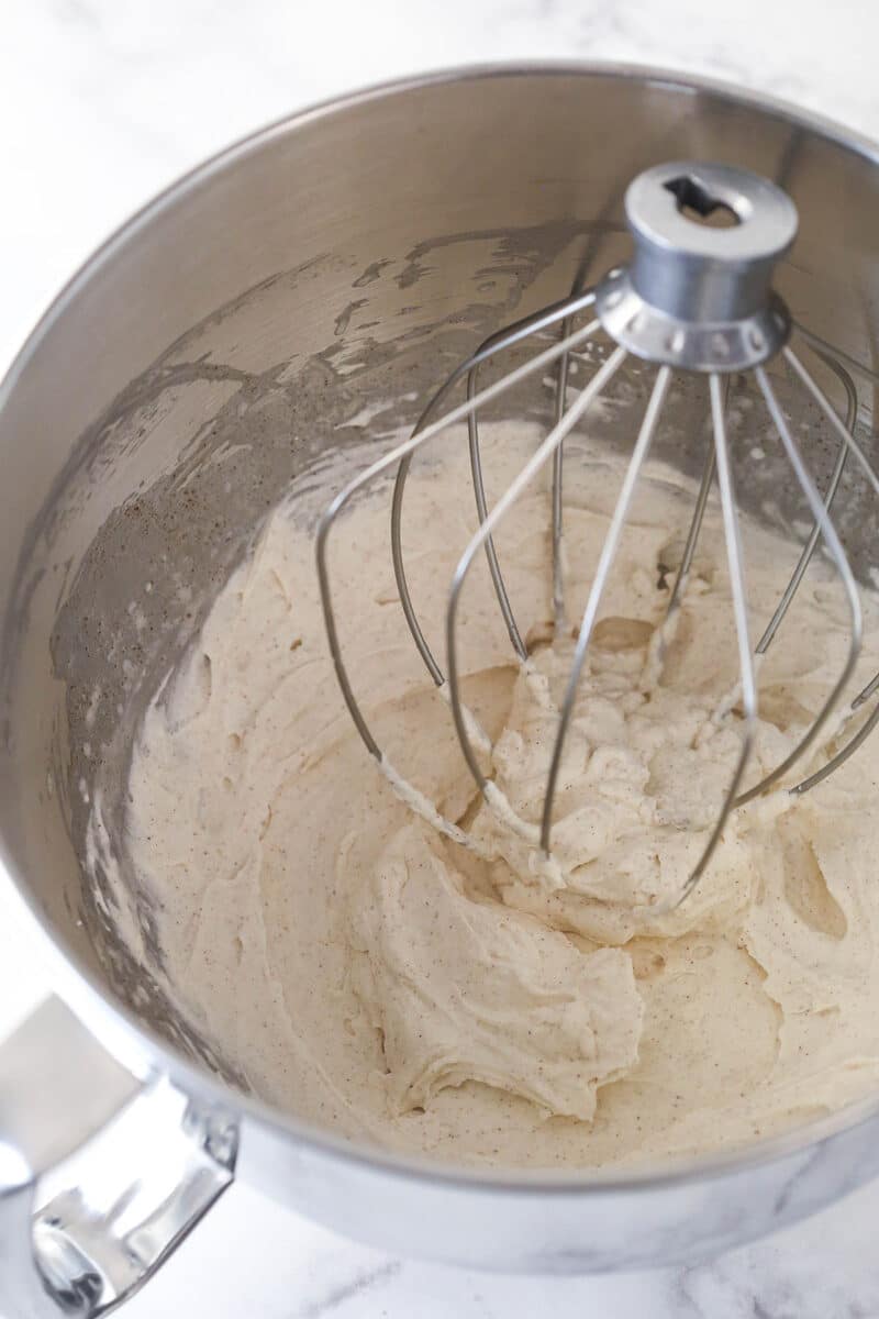 Cinnamon whipped cream in a mixing bowl.