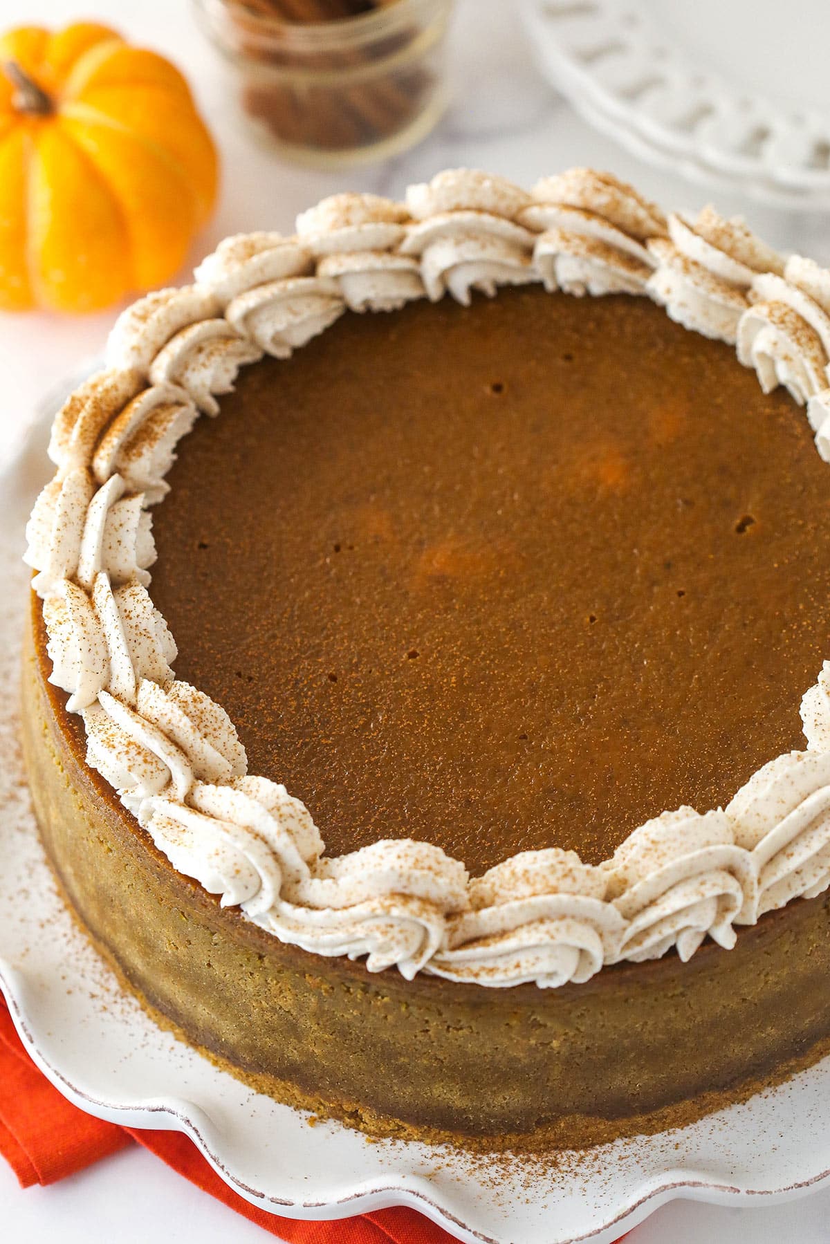 Overhead image of pumpkin pie cheesecake on a serving platter.