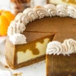 Pumpkin pie cheesecake with a slice taken out of it.