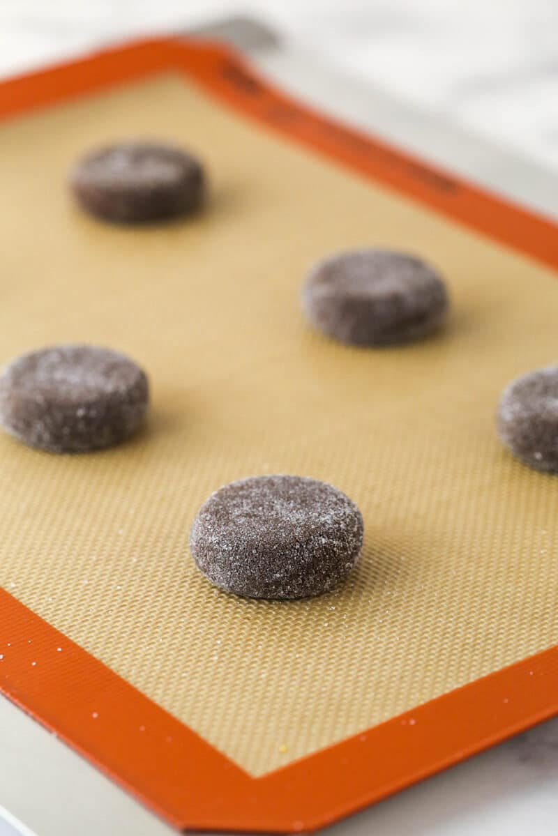 Chocolate sugar cookies flattened and ready to go in the oven.