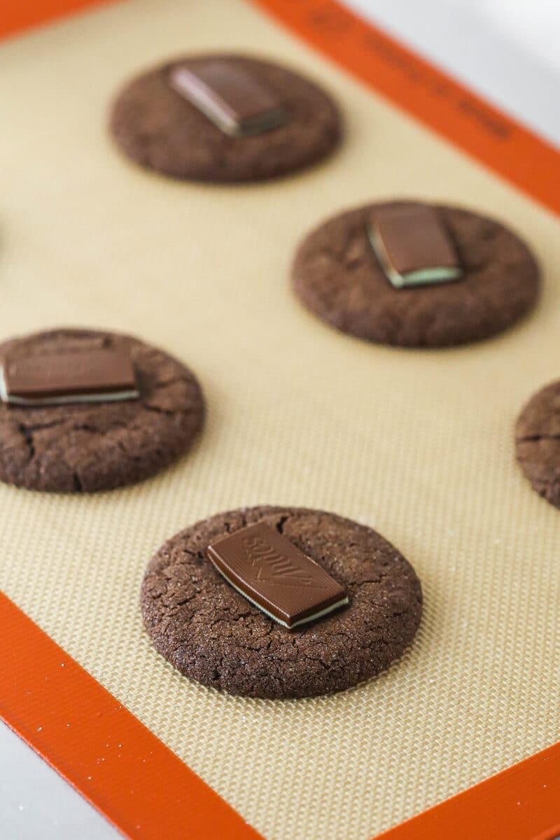 Andes mints placed on top of warm chocolate sugar cookies.