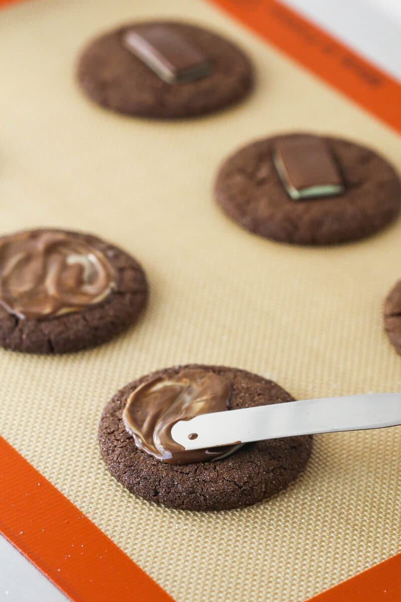 Spreading an Andes mint over a chocolate sugar cookie.