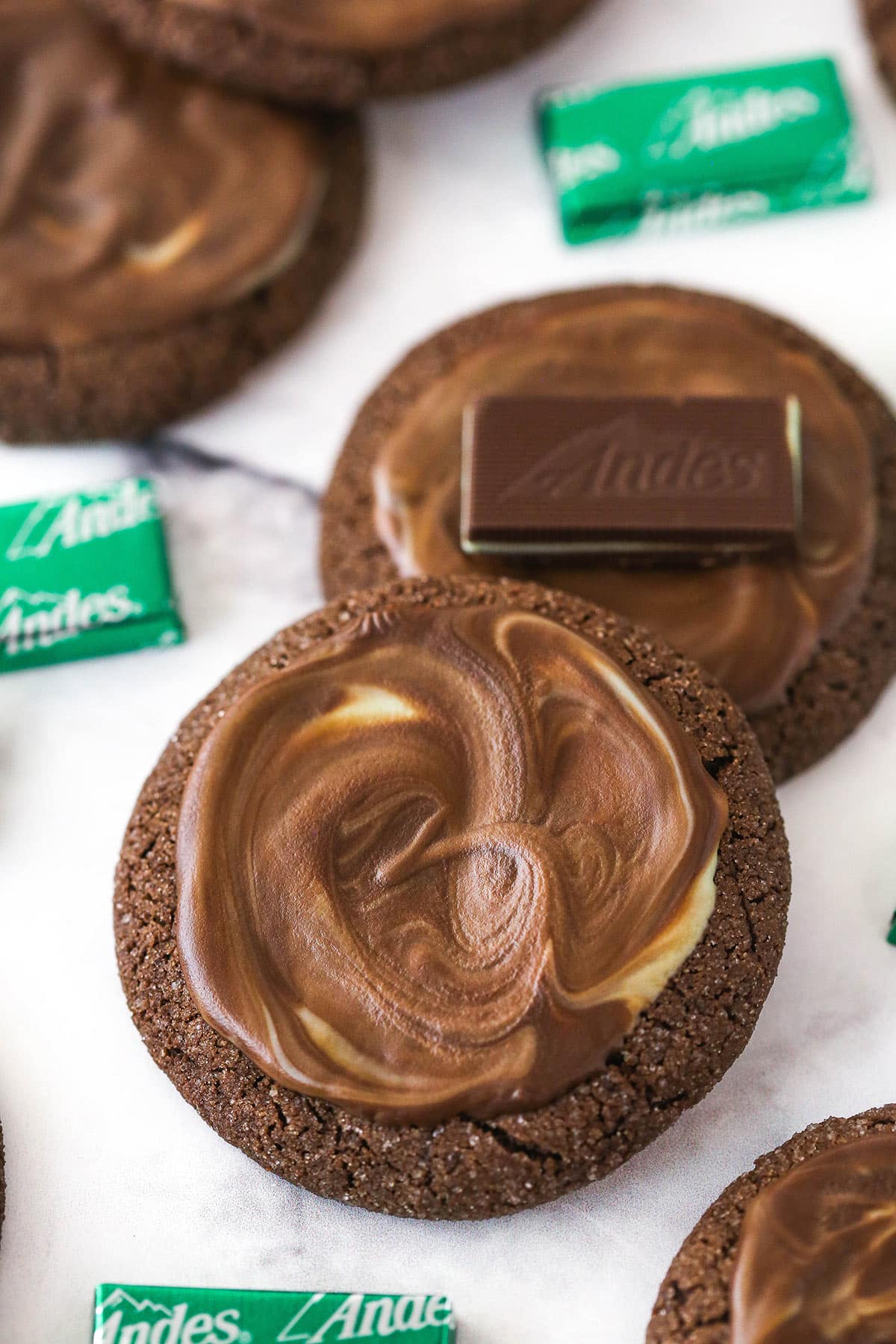 Overhead image of Andes mint cookies. One has an Andes mint on top of it.