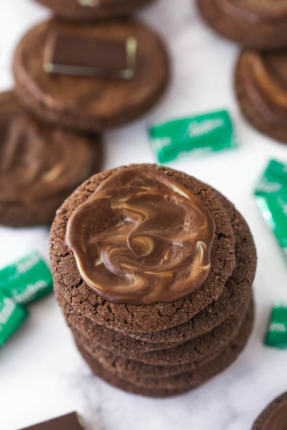 Overhead image of a stack of Andes mint cookies surrounded by Andes mints.
