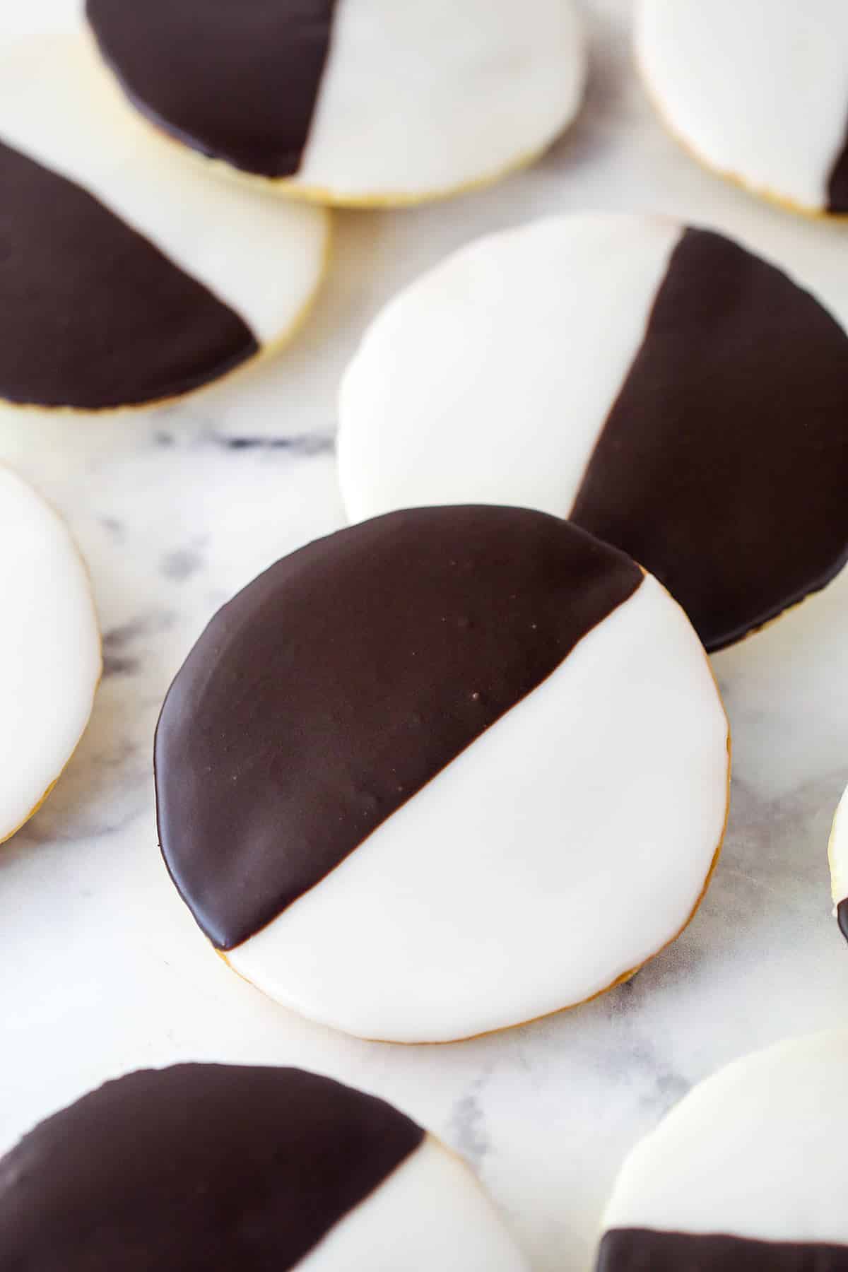 Overhead image of half moon cookies on a marble surface.