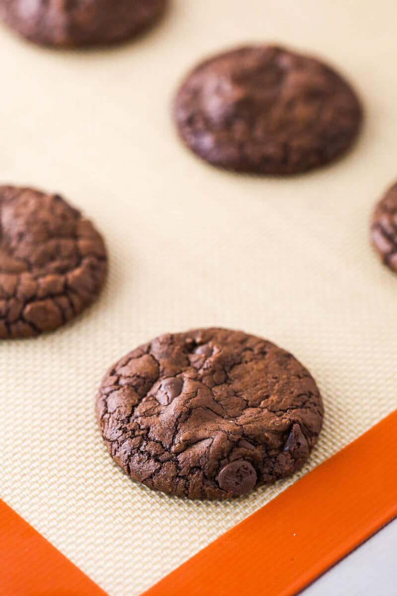 Brownie cookies on a silicone baking mat.