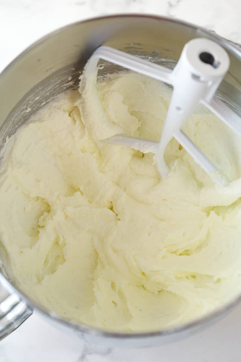 Creamed butter and sugar in a silver mixing bowl.