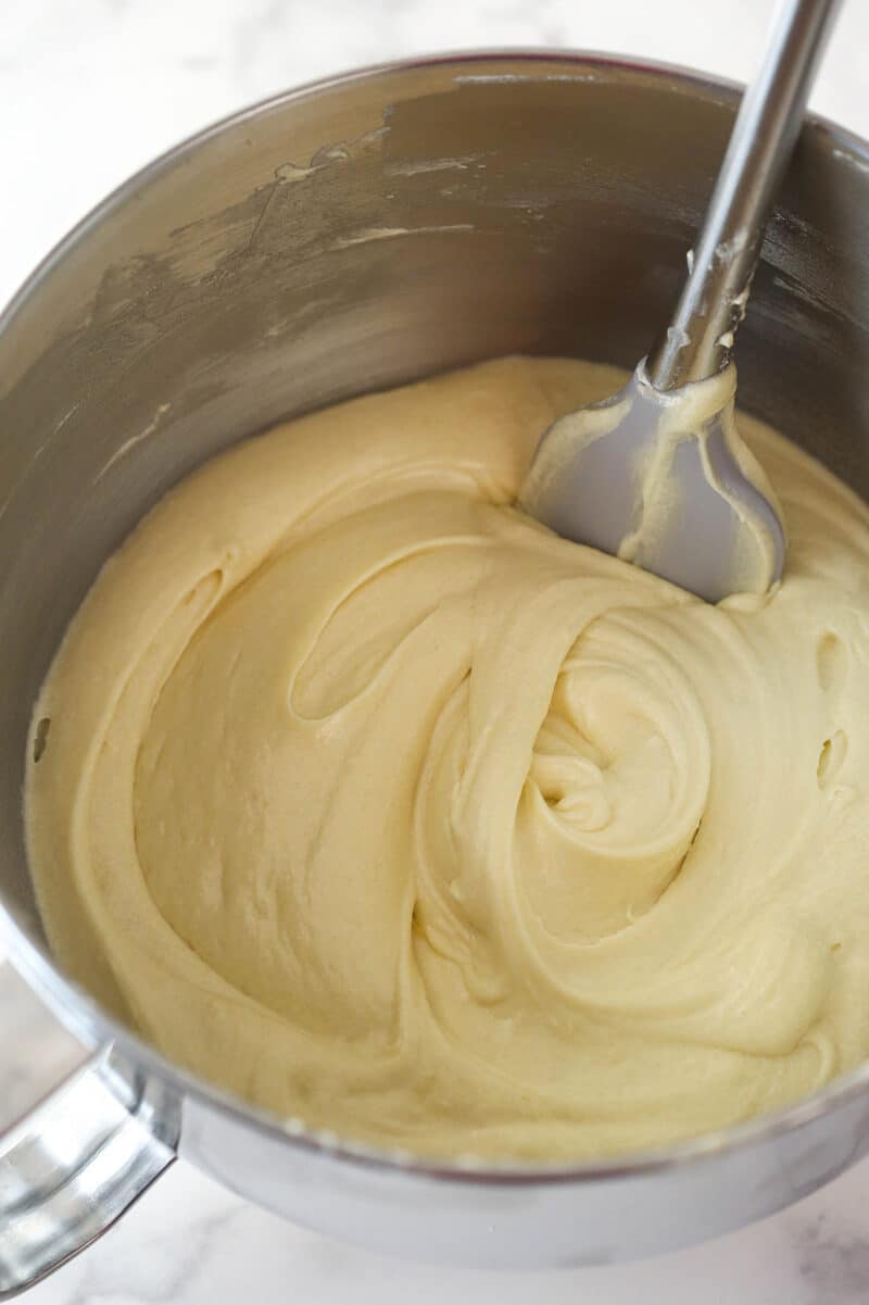 Vanilla cake batter in a silver mixing bowl.