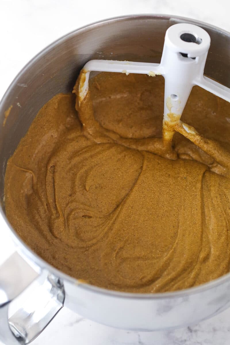 Combining wet and dry ingredients for gingerbread cake batter.