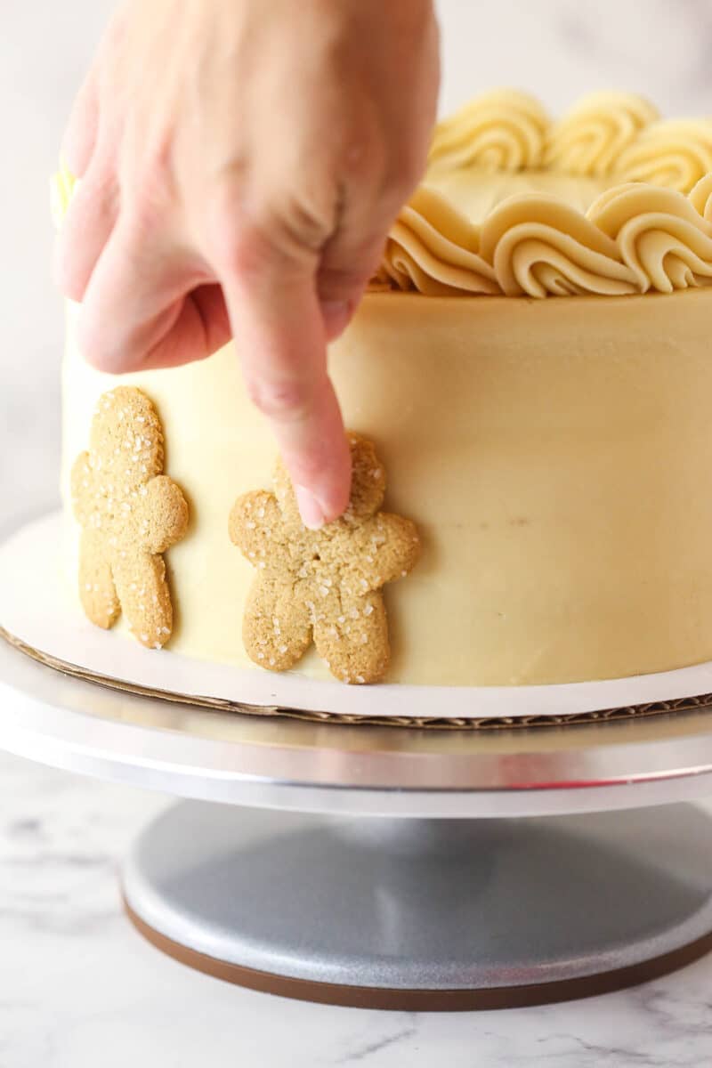 Decorating gingerbread cake with gingerbread men.