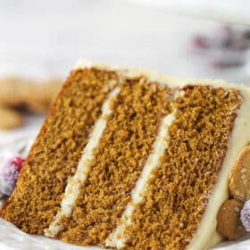 A slice of gingerbread layer cake on a plate.