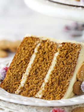 A slice of gingerbread layer cake on a plate.
