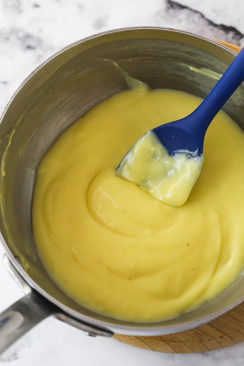 Eggnog and cornstarch mixture in a silver mixing bowl.