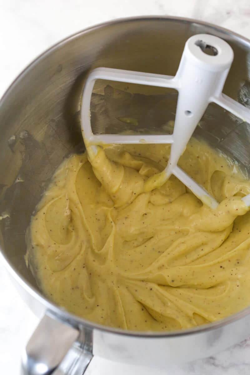 Eggnog, gelatin and cornstarch mixture in a silver mixing bowl.