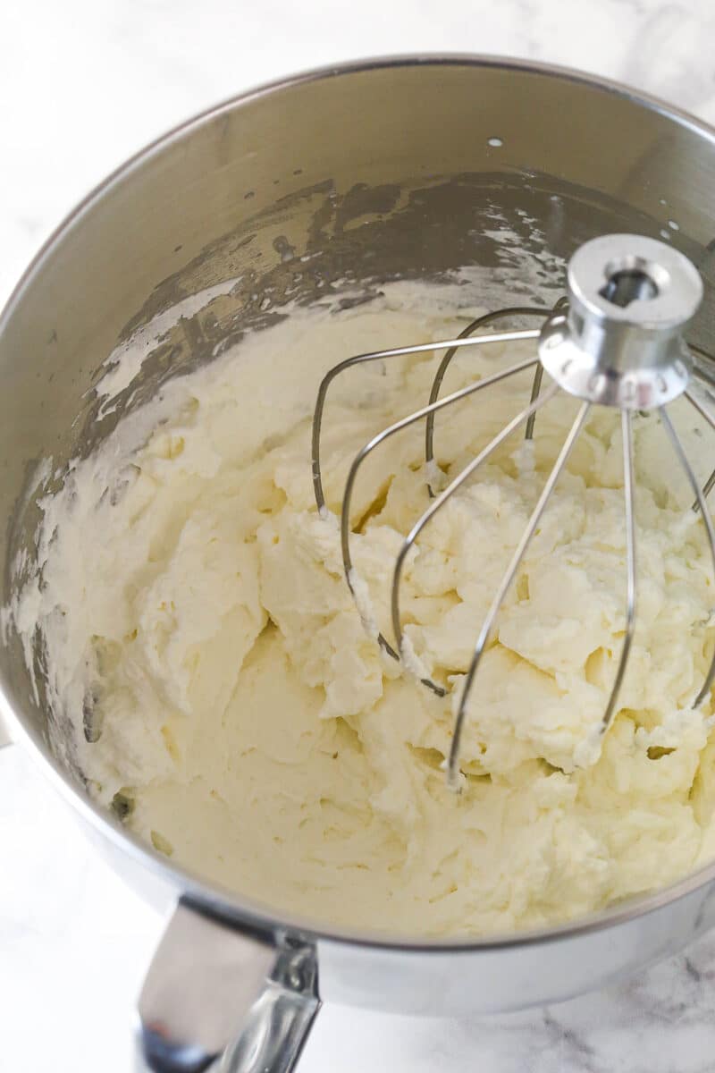 Creamed sugar and cream cheese in a mixing bowl.