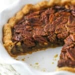 Classic Pecan Pie in a white baking pan with a slice removed.