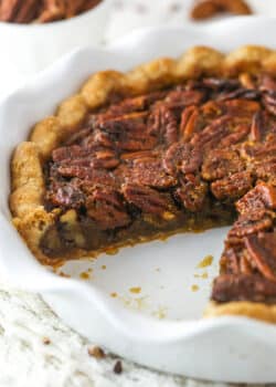 Classic Pecan Pie in a white baking pan with a slice removed.