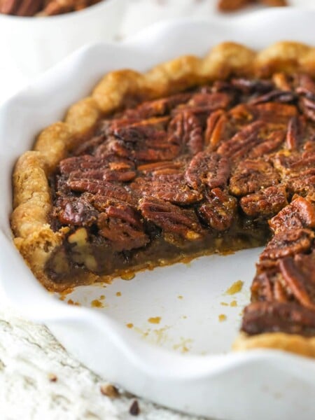 Classic Pecan Pie in a white baking pan with a slice removed.