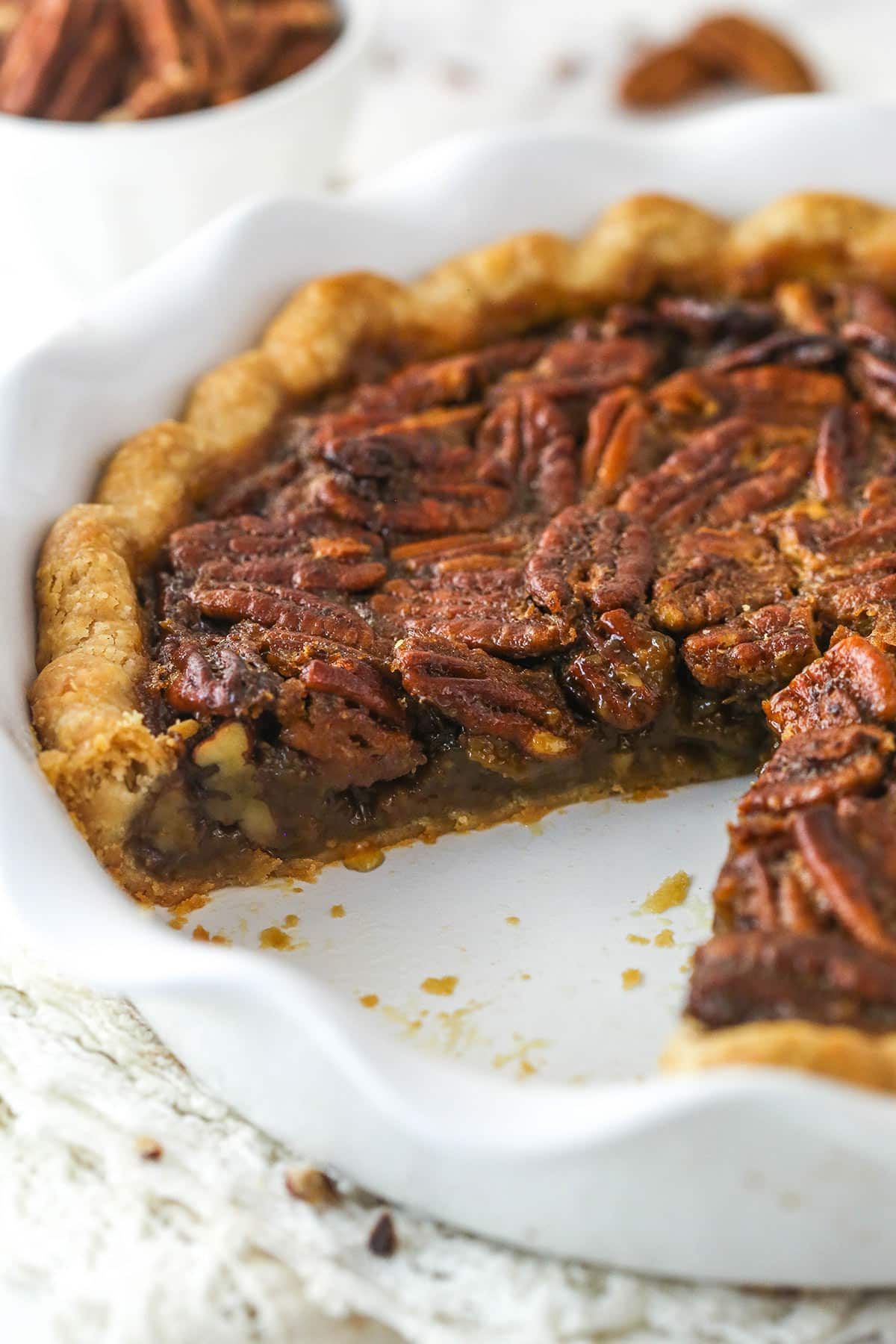 Classic Pecan Pie in a white baking pan with a slice removed.