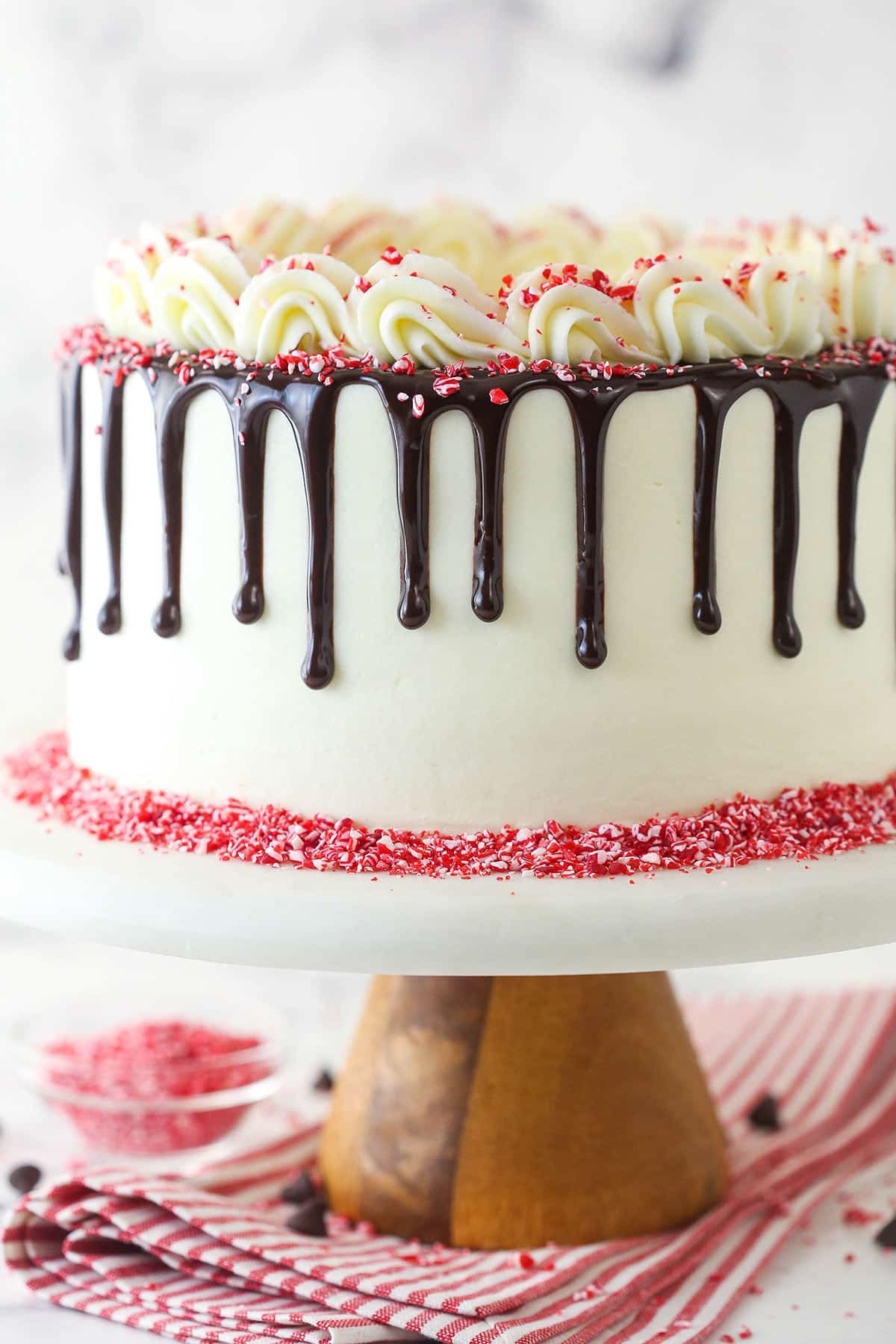 Chocolate peppermint layer cake on a cake stand.