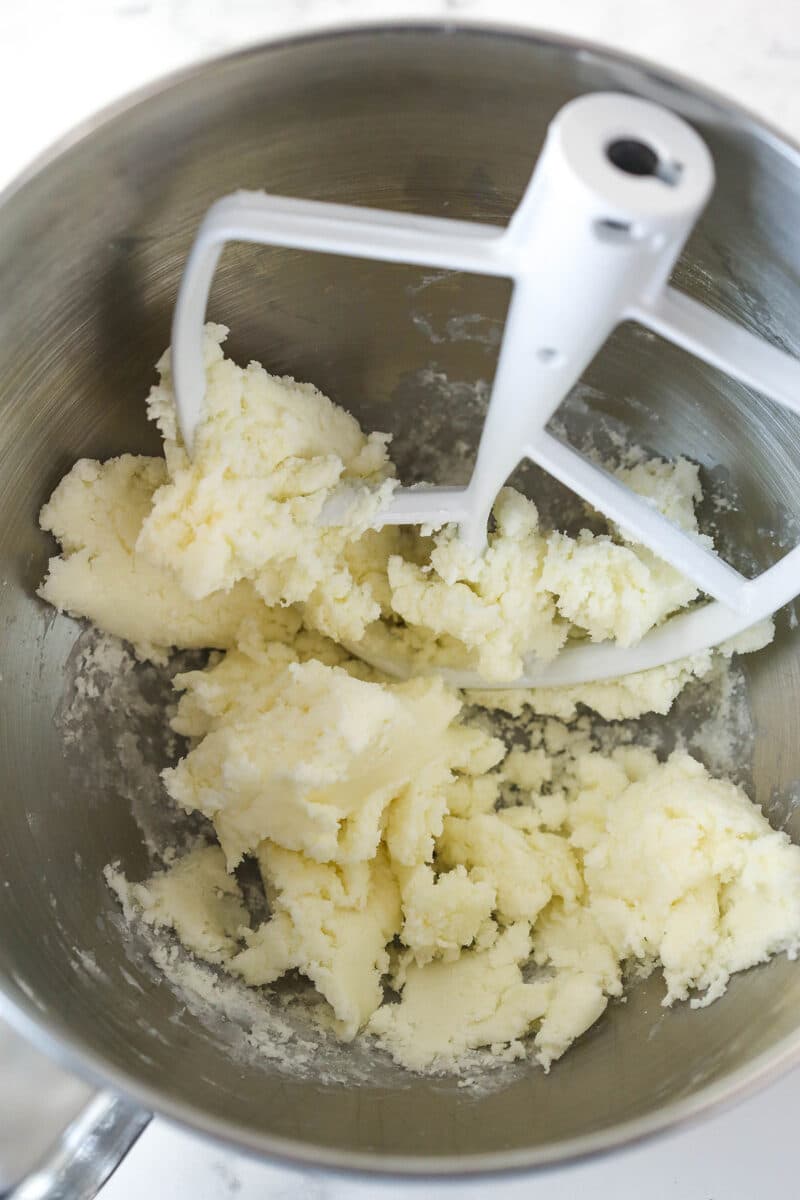 Beating together butter, corn syrup, peppermint, and vanilla to make a peppermint fondant filling.