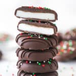 A stack of peppermint patties. The top patty is cut in half.