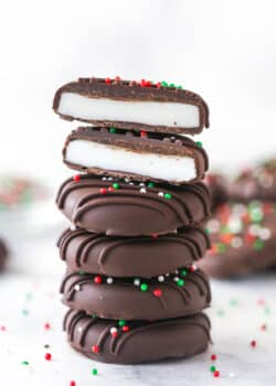 A stack of peppermint patties. The top patty is cut in half.