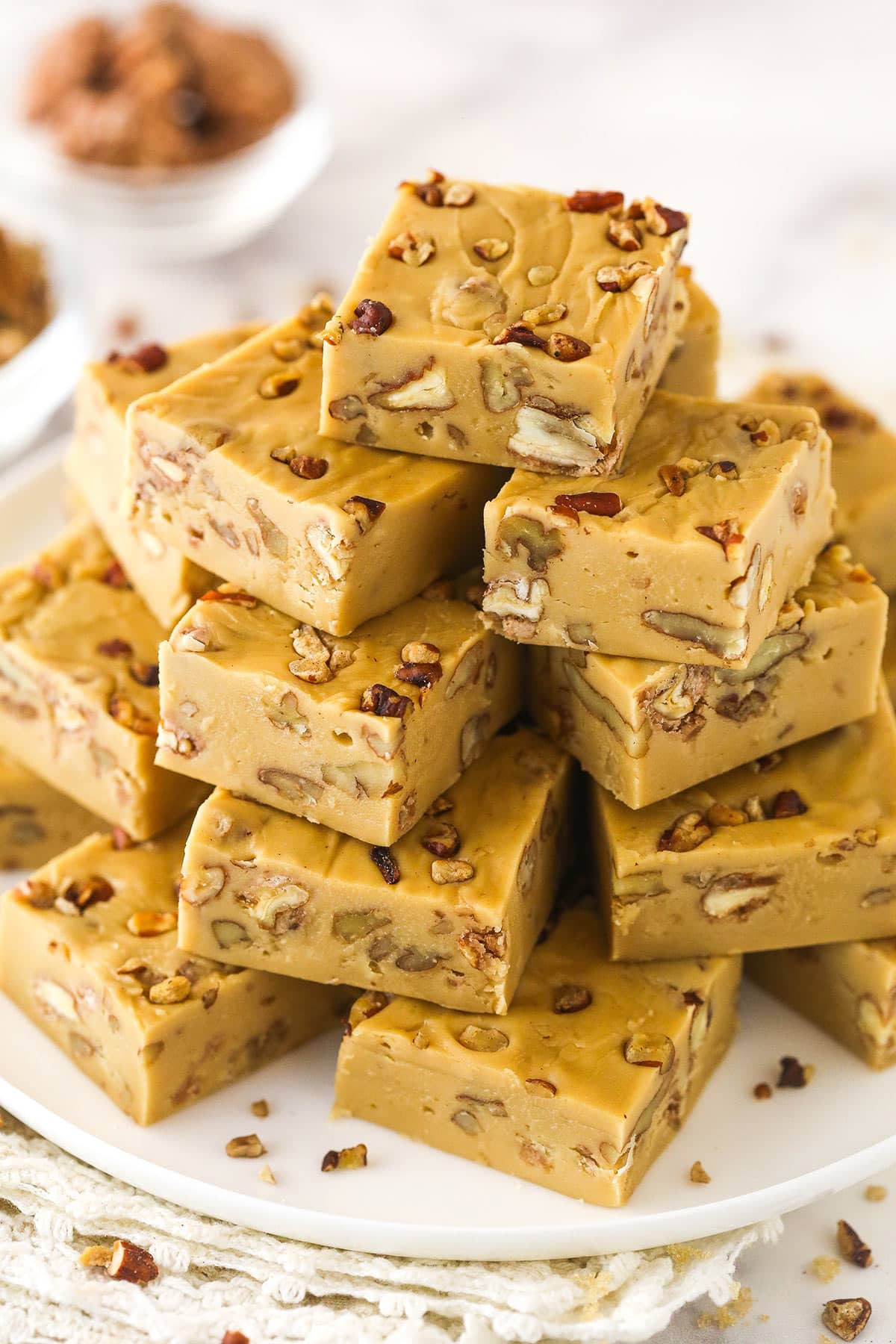 Stacks of Praline Pecan Fudge on a white plate.