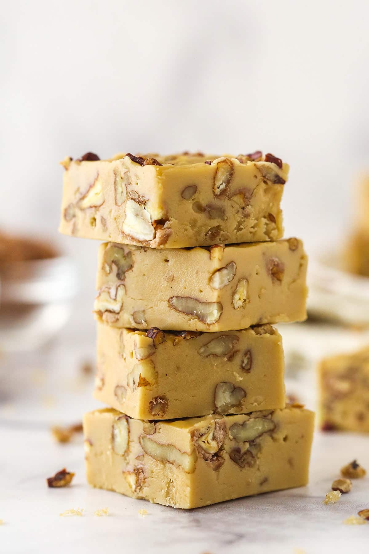 4 pieces of Praline Pecan Fudge stacked one on top of the other.