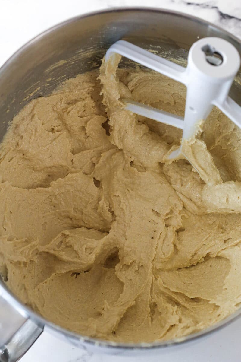 Batter for Spice Cake in a large metal mixing bowl with butter, oil, sugar and vanilla.