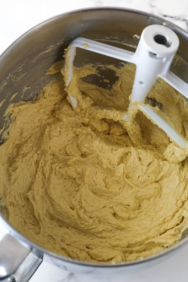 Batter for Spice Cake in a large metal mixing bowl after eggs are added.