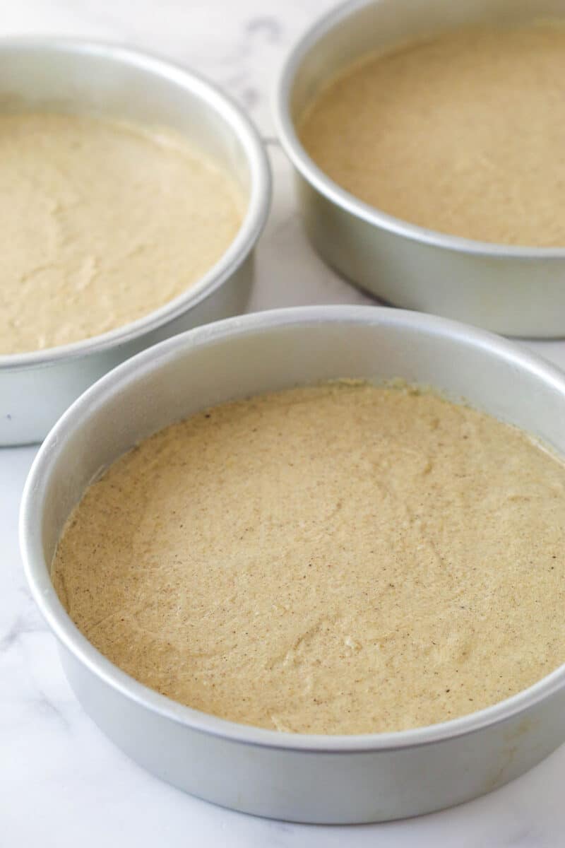 3 cake pans filled with Spice Cake batter.