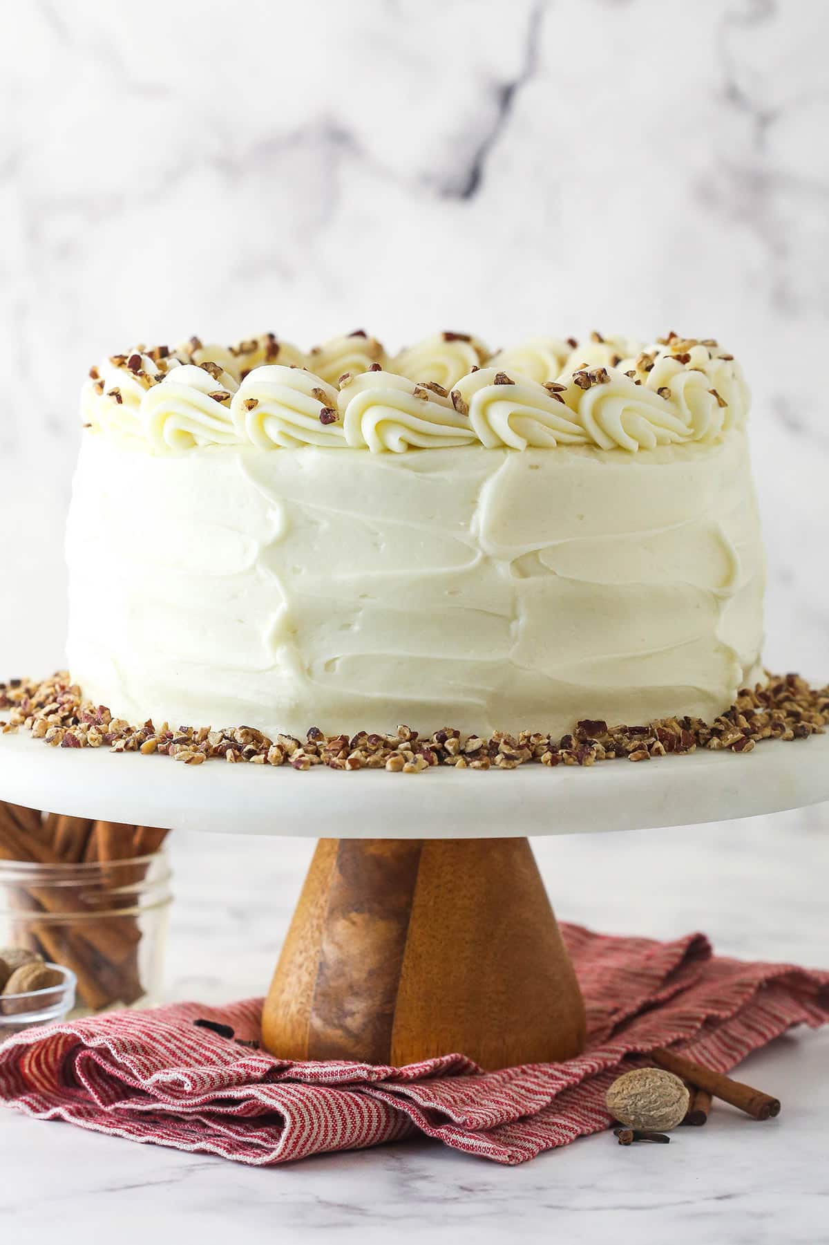 Spice Cake on a white and wood cake platter on a napkin.